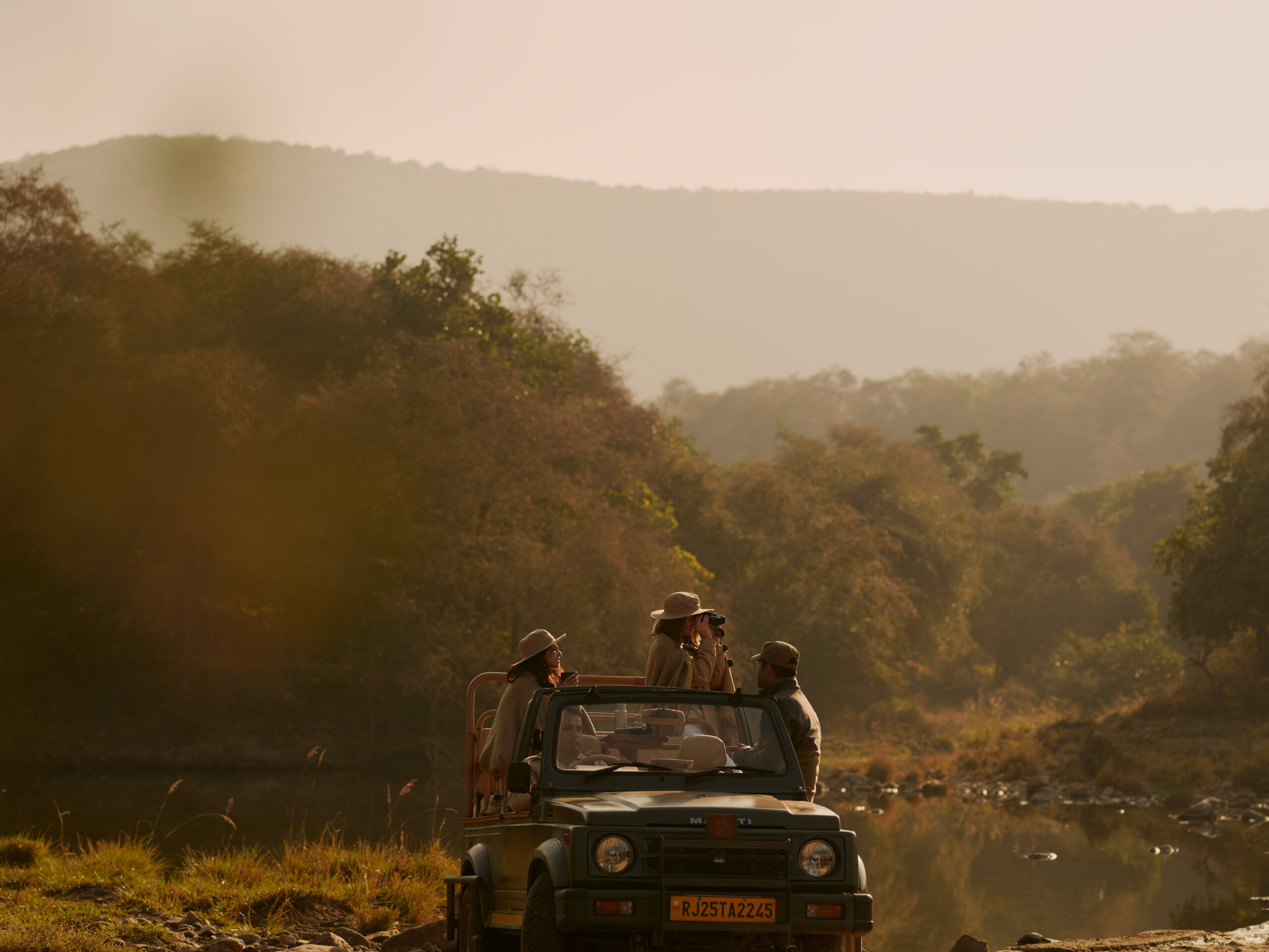 Watch the sunset to the tunes of jungle over the rugged landscape while sipping champagne on a riverbed.