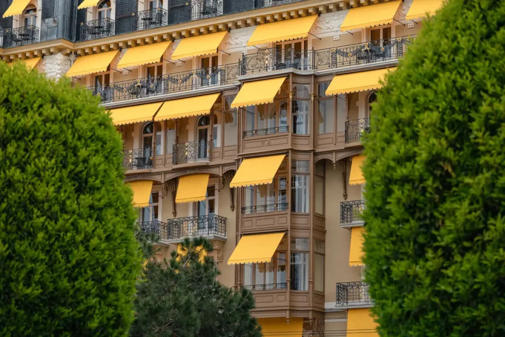 Unmissable yellow awnings of Fairmont Le Montreux Palace, which faces Swiss Alps and Geneva Lake.