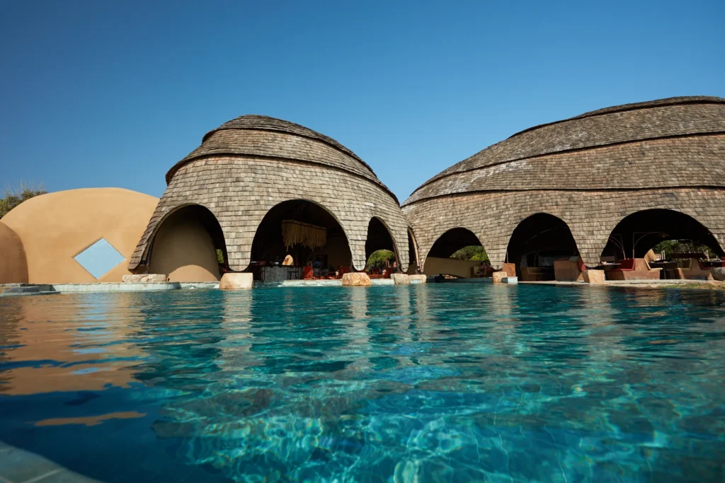 Lounge by the swimming pool which feels like a private lagoon, at sunrise or sunset.