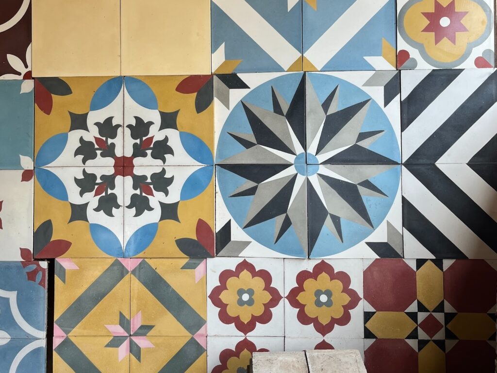 A closer look at vibrant Athangudi tiles, handcrafted with river silt and coloured oxides. 
These bold geometric patterns, unique to Chettinad, bring living history to every courtyard 
and hallway.